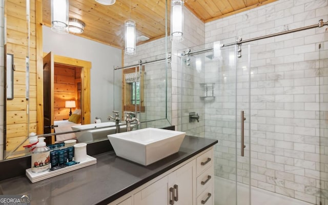 bathroom with wooden ceiling, a stall shower, and vanity