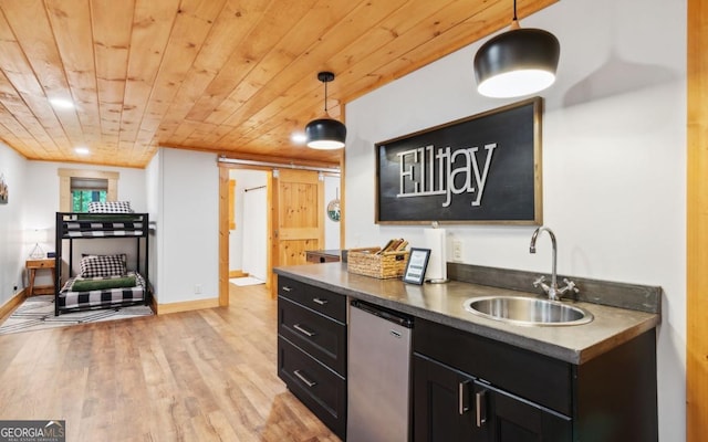 kitchen featuring a sink, fridge, dark cabinets, wooden ceiling, and light wood-style floors
