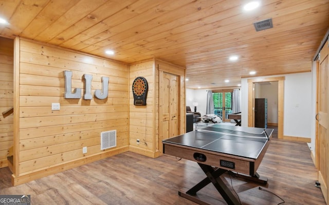 recreation room with wood ceiling, recessed lighting, wood finished floors, wood walls, and baseboards