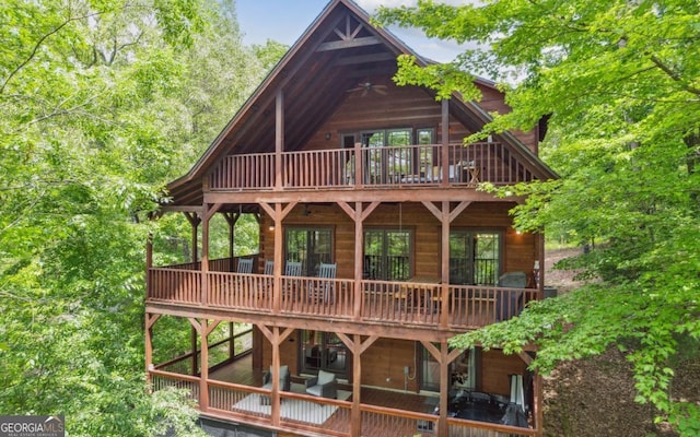 back of house featuring a wooden deck
