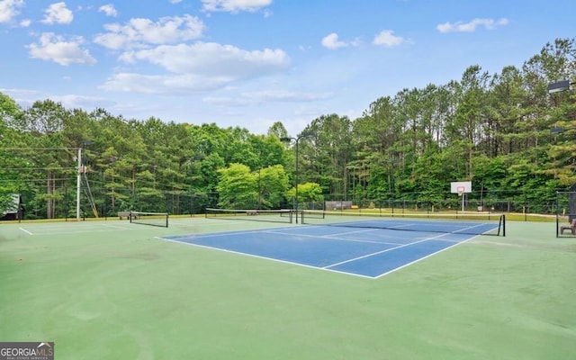 view of tennis court featuring fence