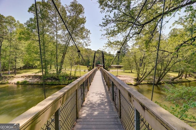 surrounding community with a water view and view of scattered trees