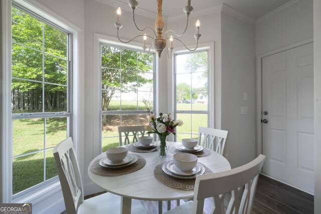 3047 Standing Rock Ct, Lithia Springs, GA 30122 - dining room with wood finished floors, an inviting chandelier, and crown molding