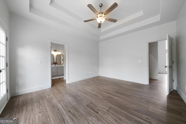 3047 Standing Rock Ct, Lithia Springs, GA 30122 - unfurnished bedroom featuring wood finished floors, a raised ceiling, and multiple windows
