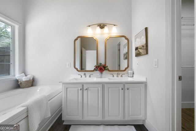 3047 Standing Rock Ct, Lithia Springs, GA 30122 - full bath with a bath, double vanity, a sink, and a walk in closet