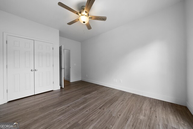 3047 Standing Rock Ct, Lithia Springs, GA 30122 - unfurnished bedroom with ceiling fan, baseboards, wood finished floors, and a closet