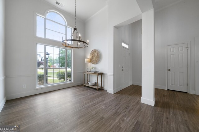 3047 Standing Rock Ct, Lithia Springs, GA 30122 - unfurnished dining area featuring baseboards, visible vents, a notable chandelier, a high ceiling, and crown molding
