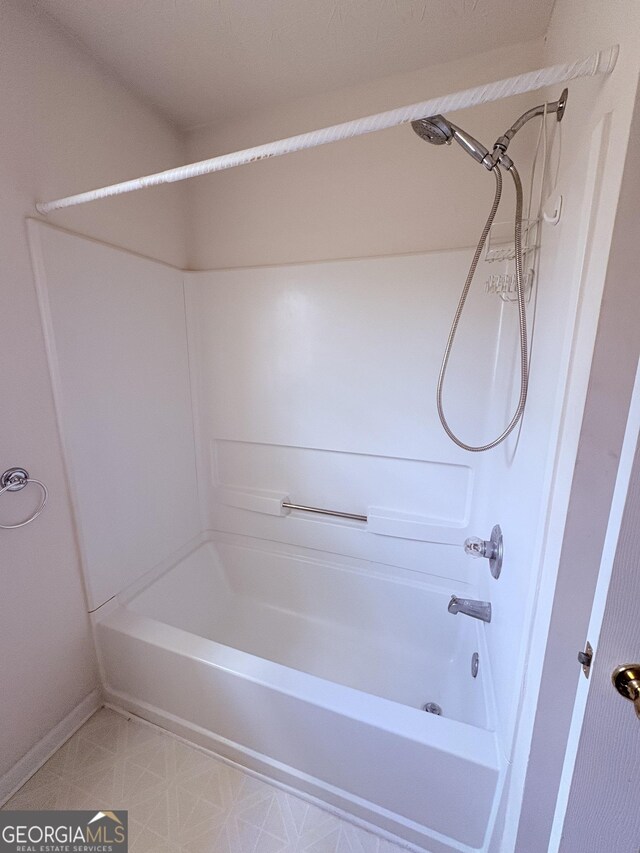 bathroom with baseboards and bathtub / shower combination