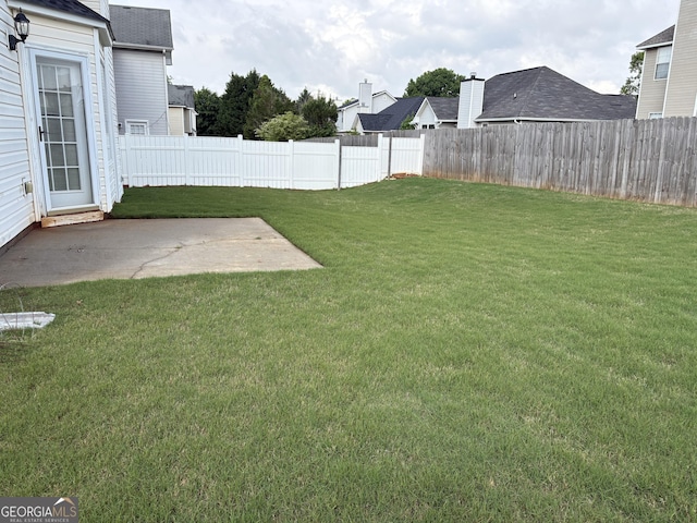 view of yard with a fenced backyard and a patio
