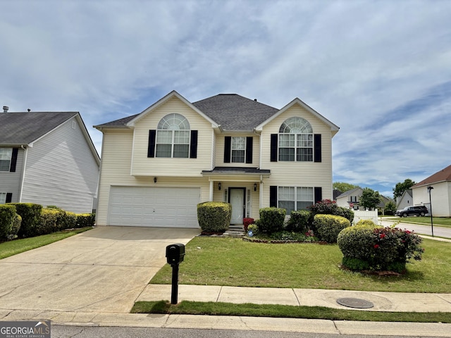 traditional-style home featuring concrete driveway, a shingled roof, a front yard, and a garage