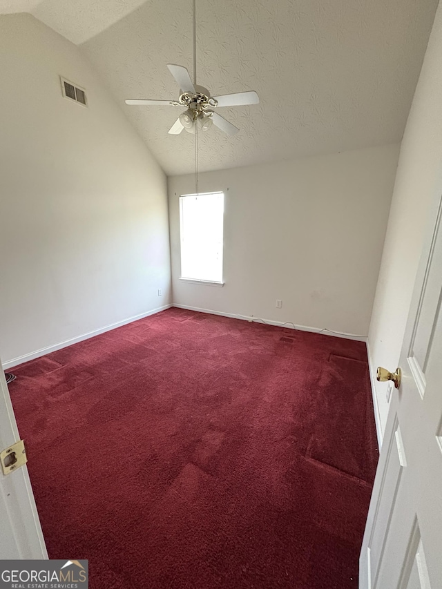 carpeted spare room with visible vents, baseboards, ceiling fan, and lofted ceiling
