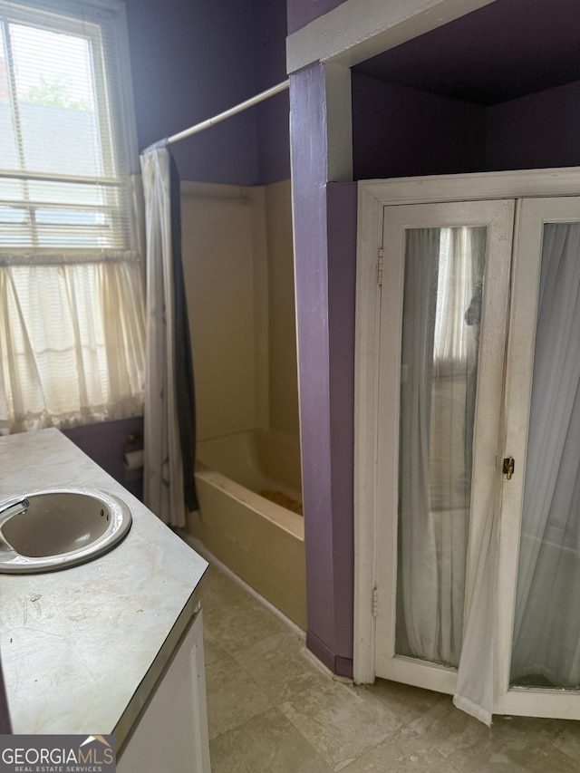 967 Cole St, Macon, GA 31201 - bathroom with shower / tub combo with curtain and vanity