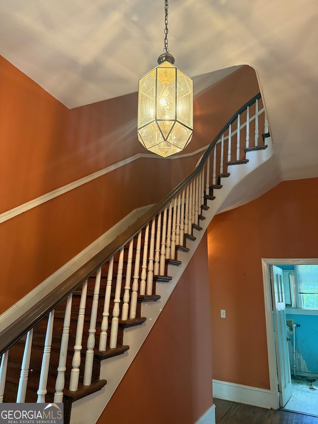 967 Cole St, Macon, GA 31201 - stairs with baseboards, a notable chandelier, and wood finished floors