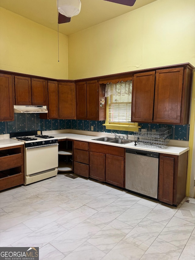 967 Cole St, Macon, GA 31201 - kitchen featuring stainless steel dishwasher, a towering ceiling, white gas range oven, light countertops, and backsplash