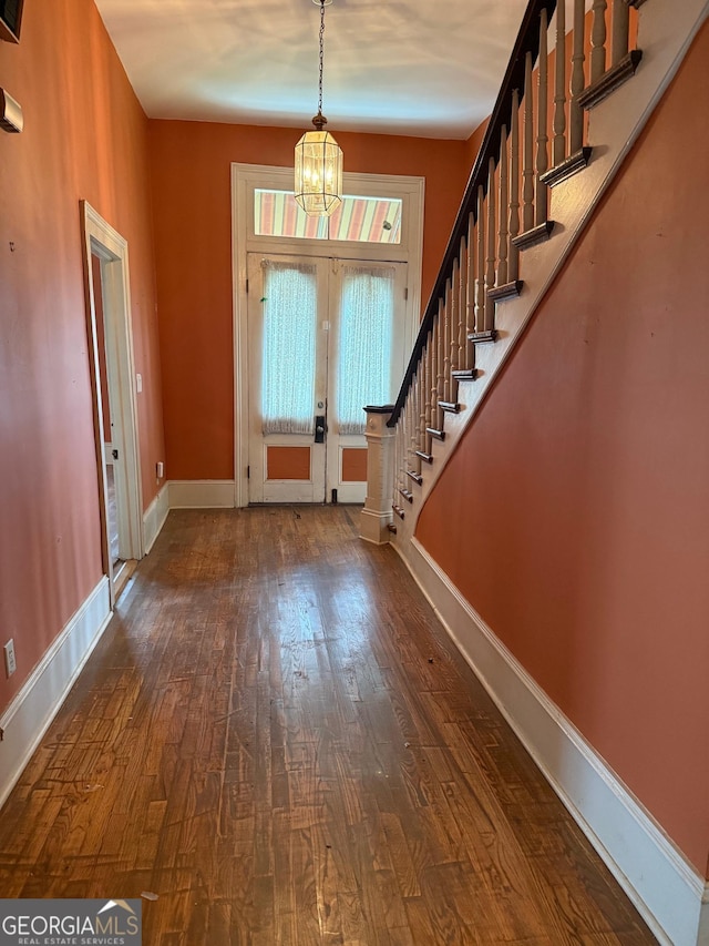 967 Cole St, Macon, GA 31201 - foyer entrance featuring baseboards, an inviting chandelier, stairs, and dark wood finished floors