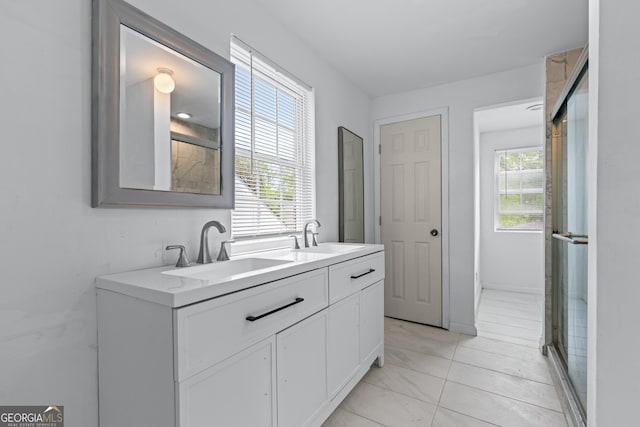 full bathroom featuring a sink, an enclosed shower, double vanity, and marble finish floor