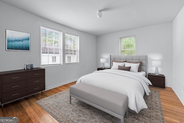 bedroom with baseboards and light wood-type flooring