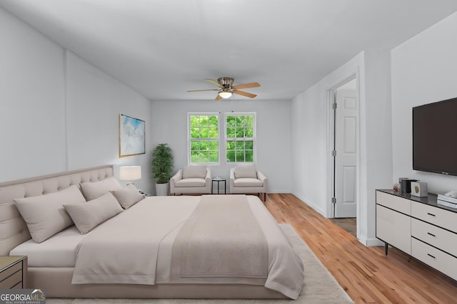 bedroom with baseboards, light wood finished floors, and ceiling fan