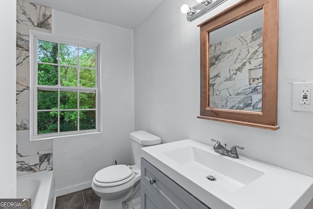 full bathroom with vanity, toilet, marble finish floor, baseboards, and a tub to relax in