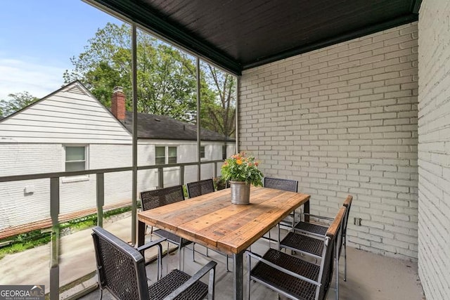 sunroom with outdoor dining area