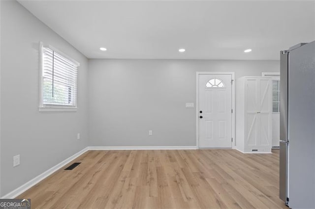 foyer with visible vents, baseboards, recessed lighting, and light wood-style floors