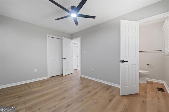 unfurnished bedroom with light wood finished floors, baseboards, visible vents, a ceiling fan, and a closet