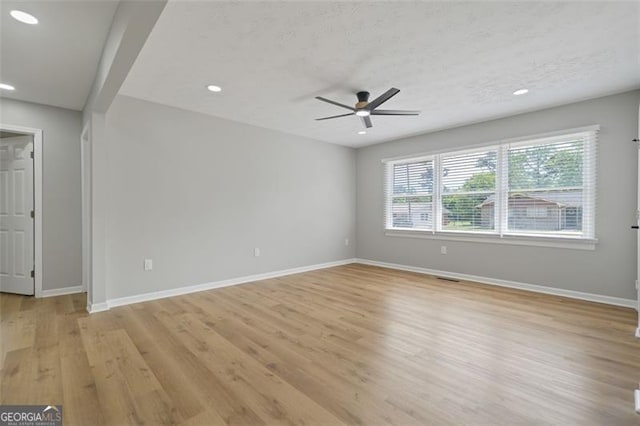 spare room featuring recessed lighting, light wood-type flooring, baseboards, and ceiling fan