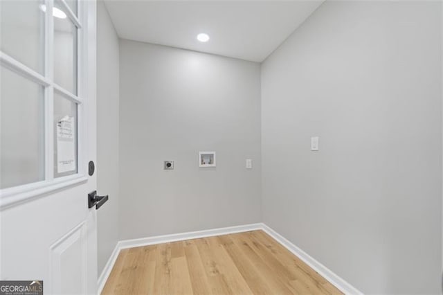 laundry area with electric dryer hookup, light wood-type flooring, baseboards, laundry area, and washer hookup