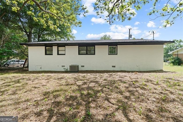 back of property featuring central air condition unit and crawl space
