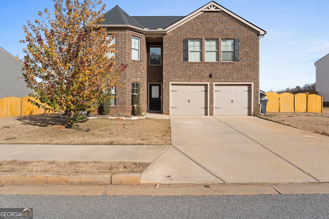 traditional-style home featuring fence, roof with shingles, concrete driveway, brick siding, and a garage