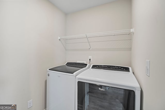 clothes washing area with washing machine and dryer and laundry area