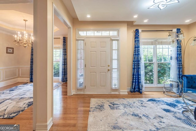 4319 Silver Peak Pkwy, Suwanee, GA 30024 - foyer with wainscoting, an inviting chandelier, wood finished floors, and recessed lighting