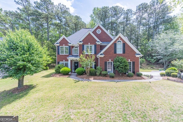 4319 Silver Peak Pkwy, Suwanee, GA 30024 - colonial inspired home with a front lawn and brick siding