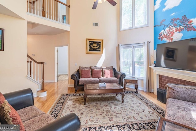 4319 Silver Peak Pkwy, Suwanee, GA 30024 - living room featuring baseboards, wood finished floors, a high ceiling, and stairs