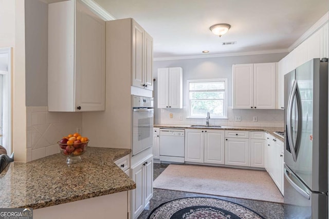 4319 Silver Peak Pkwy, Suwanee, GA 30024 - kitchen featuring backsplash, visible vents, a sink, white appliances, and dark stone counters