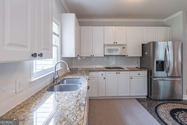 4319 Silver Peak Pkwy, Suwanee, GA 30024 - kitchen featuring gas cooktop, a sink, stainless steel fridge, white microwave, and white cabinetry