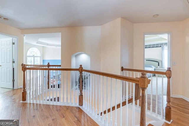 4319 Silver Peak Pkwy, Suwanee, GA 30024 - corridor featuring baseboards, wood finished floors, and an upstairs landing