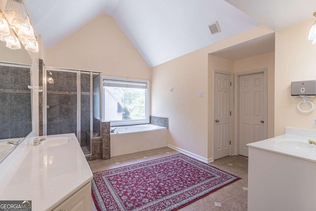 4319 Silver Peak Pkwy, Suwanee, GA 30024 - bathroom featuring a shower stall, tile patterned floors, vaulted ceiling, a bath, and two vanities