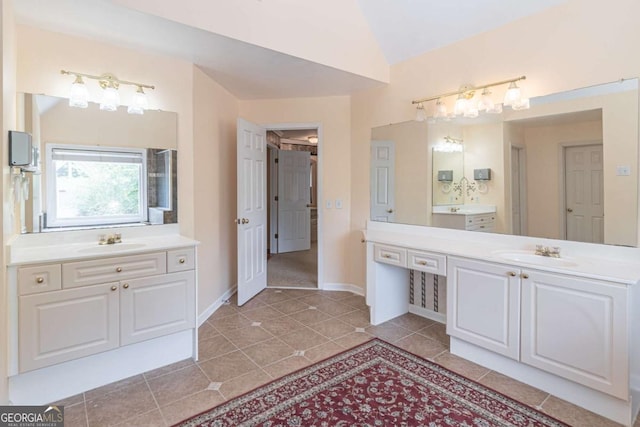 4319 Silver Peak Pkwy, Suwanee, GA 30024 - bathroom with two vanities, lofted ceiling, tile patterned flooring, and a sink
