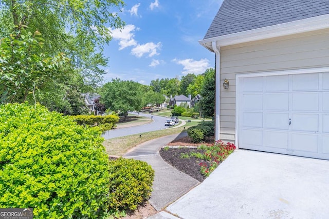4319 Silver Peak Pkwy, Suwanee, GA 30024 - exterior space with a garage, driveway, and a shingled roof