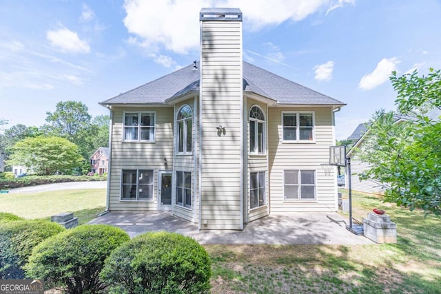 4319 Silver Peak Pkwy, Suwanee, GA 30024 - rear view of house with a yard, a chimney, roof with shingles, and a patio area