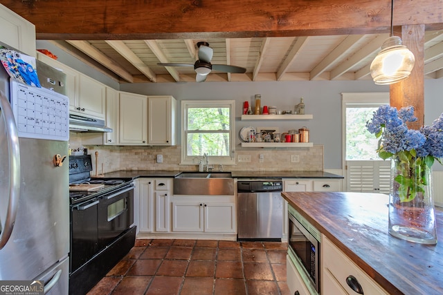 9240 Lisa Cir, Gainesville, GA 30506 - kitchen with stainless steel appliances, under cabinet range hood, wooden counters, a ceiling fan, and decorative backsplash