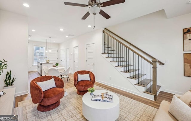 1095 Tucker Ave Unit 207, Atlanta, GA 30310 - living room featuring light wood-style floors, stairs, a ceiling fan, recessed lighting, and baseboards