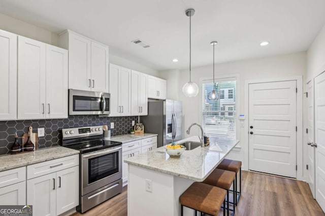 1095 Tucker Ave Unit 207, Atlanta, GA 30310 - kitchen with appliances with stainless steel finishes, a sink, wood finished floors, decorative backsplash, and recessed lighting