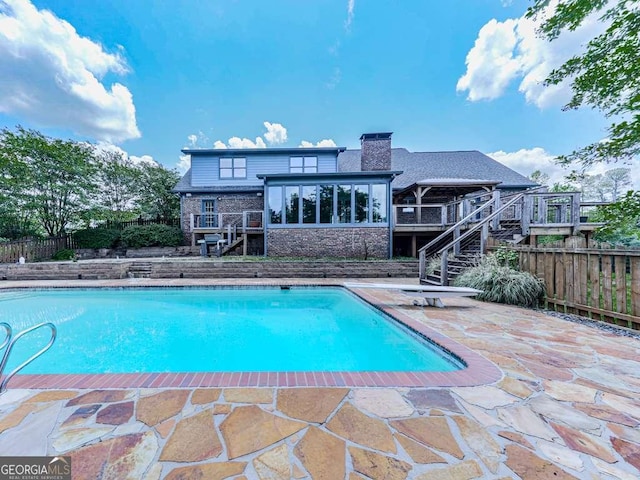 view of pool featuring stairway, a patio area, fence, a fenced in pool, and a wooden deck