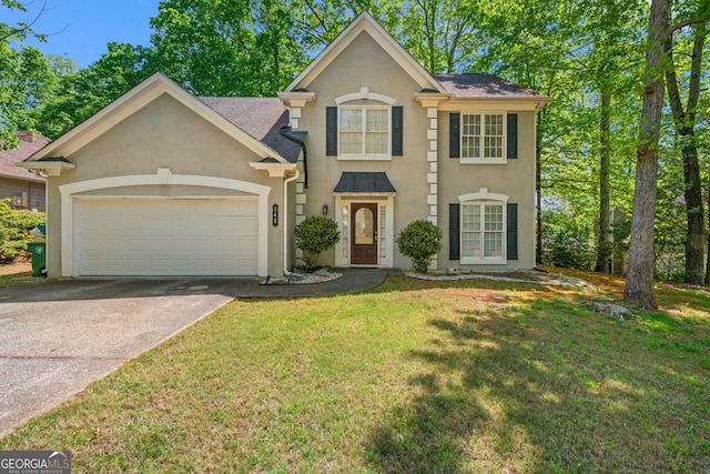 colonial house with an attached garage, a front lawn, driveway, and stucco siding