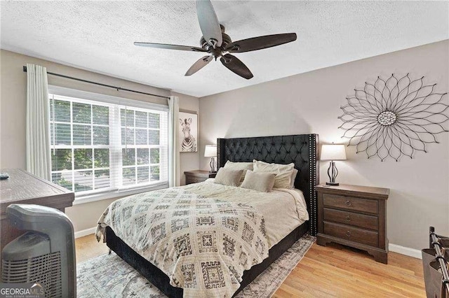 5566 River Heights Xing SE, Marietta, GA 30067 - bedroom with baseboards, a ceiling fan, a textured ceiling, and light wood-style floors