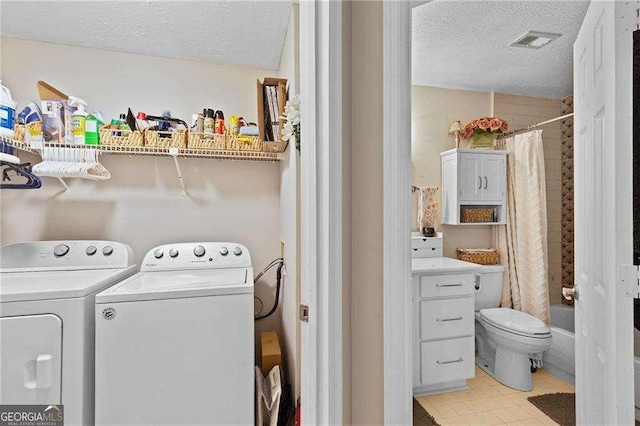 5566 River Heights Xing SE, Marietta, GA 30067 - clothes washing area with separate washer and dryer, visible vents, a textured ceiling, and laundry area