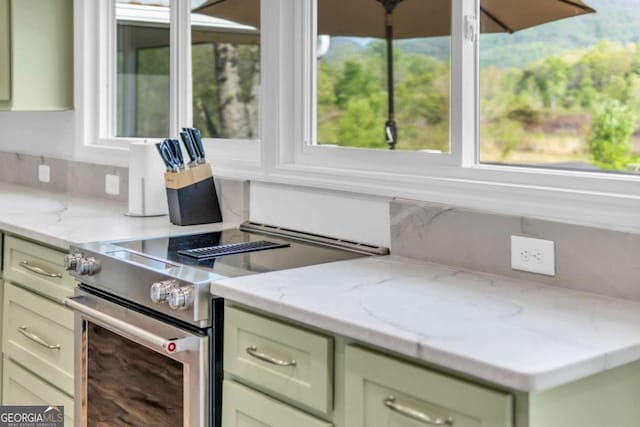 2180 Pine Lake Rd, Hiawassee, GA 30546 - kitchen with plenty of natural light, light stone counters, and stainless steel range with electric stovetop