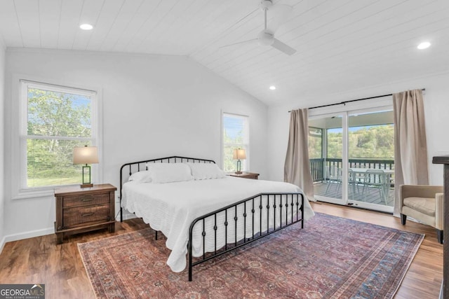 2180 Pine Lake Rd, Hiawassee, GA 30546 - bedroom with multiple windows, vaulted ceiling, wood finished floors, and access to exterior